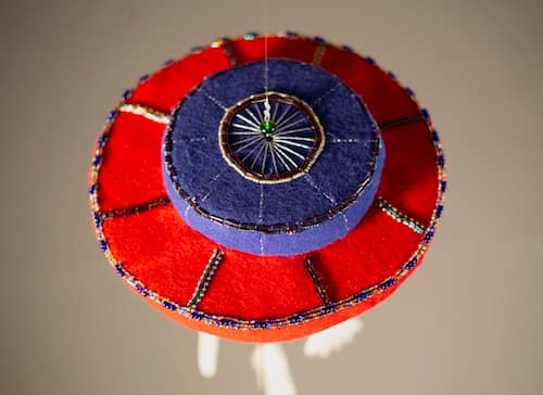 The top of a felt and beaded chime.