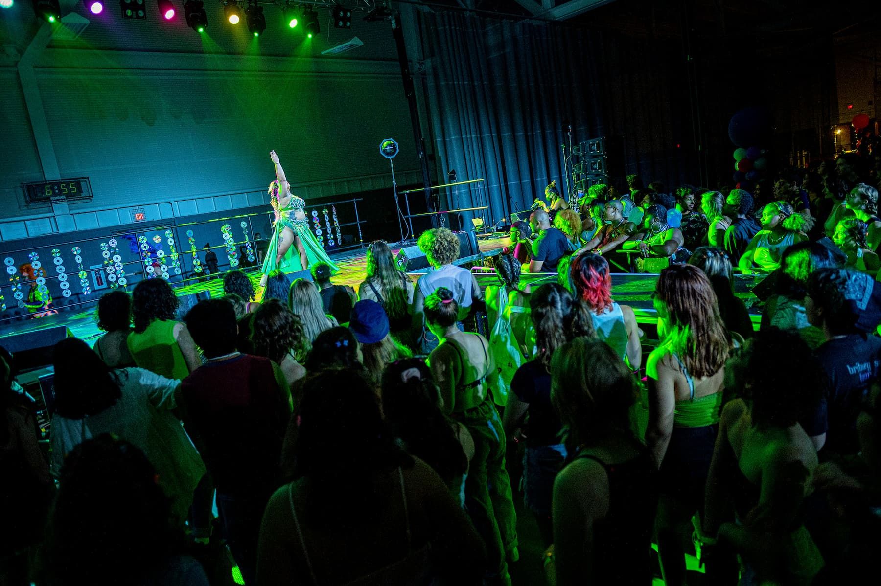 A large crowd looks at a dancer on stage.