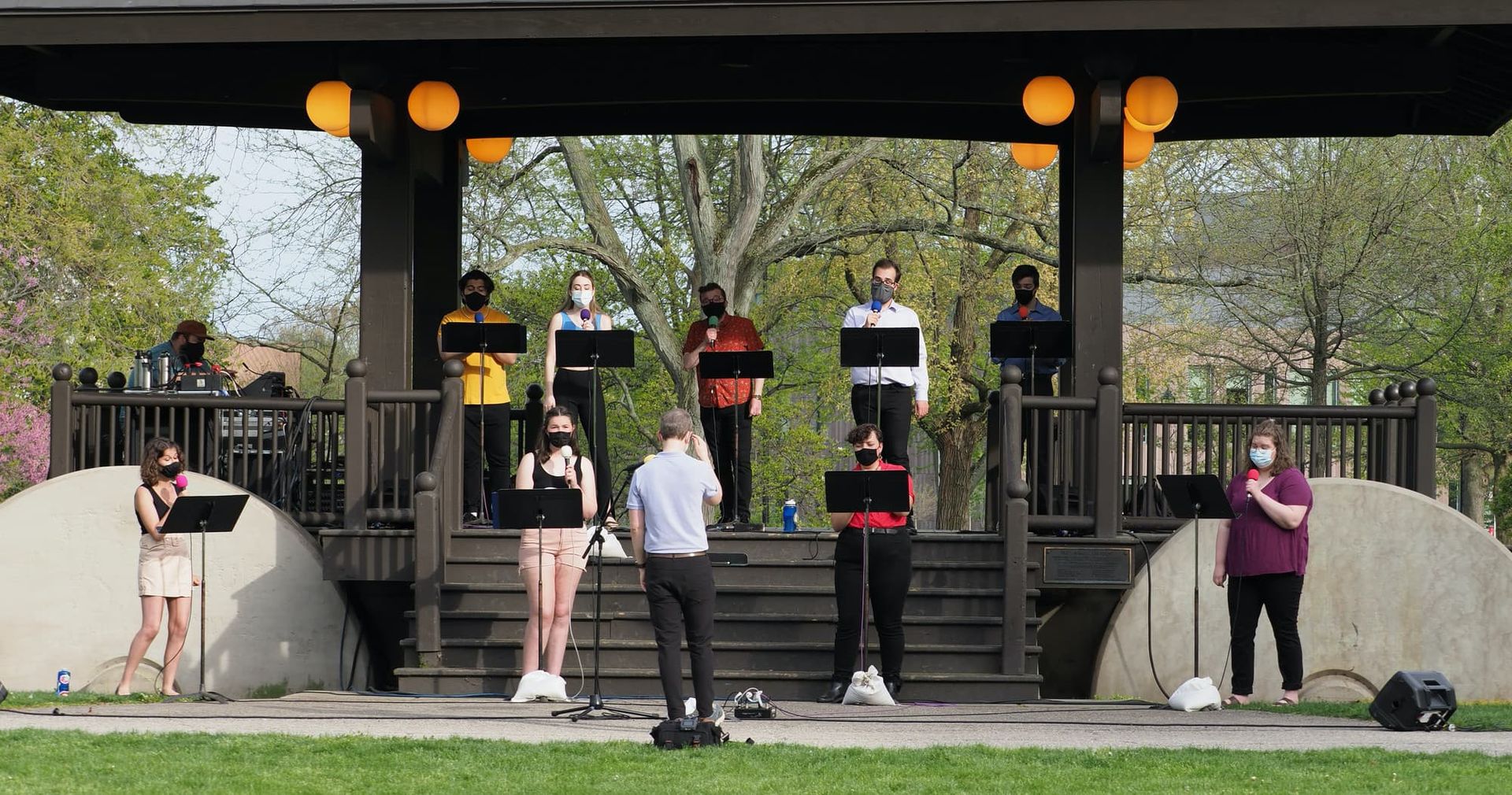 A chamber vocal group give an outdoor performance.