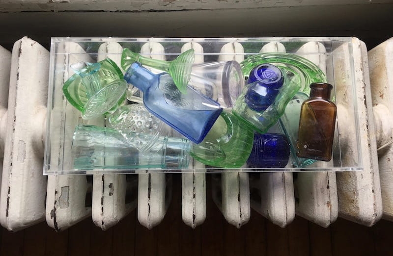Glass bottles and broken bottles in a clear box