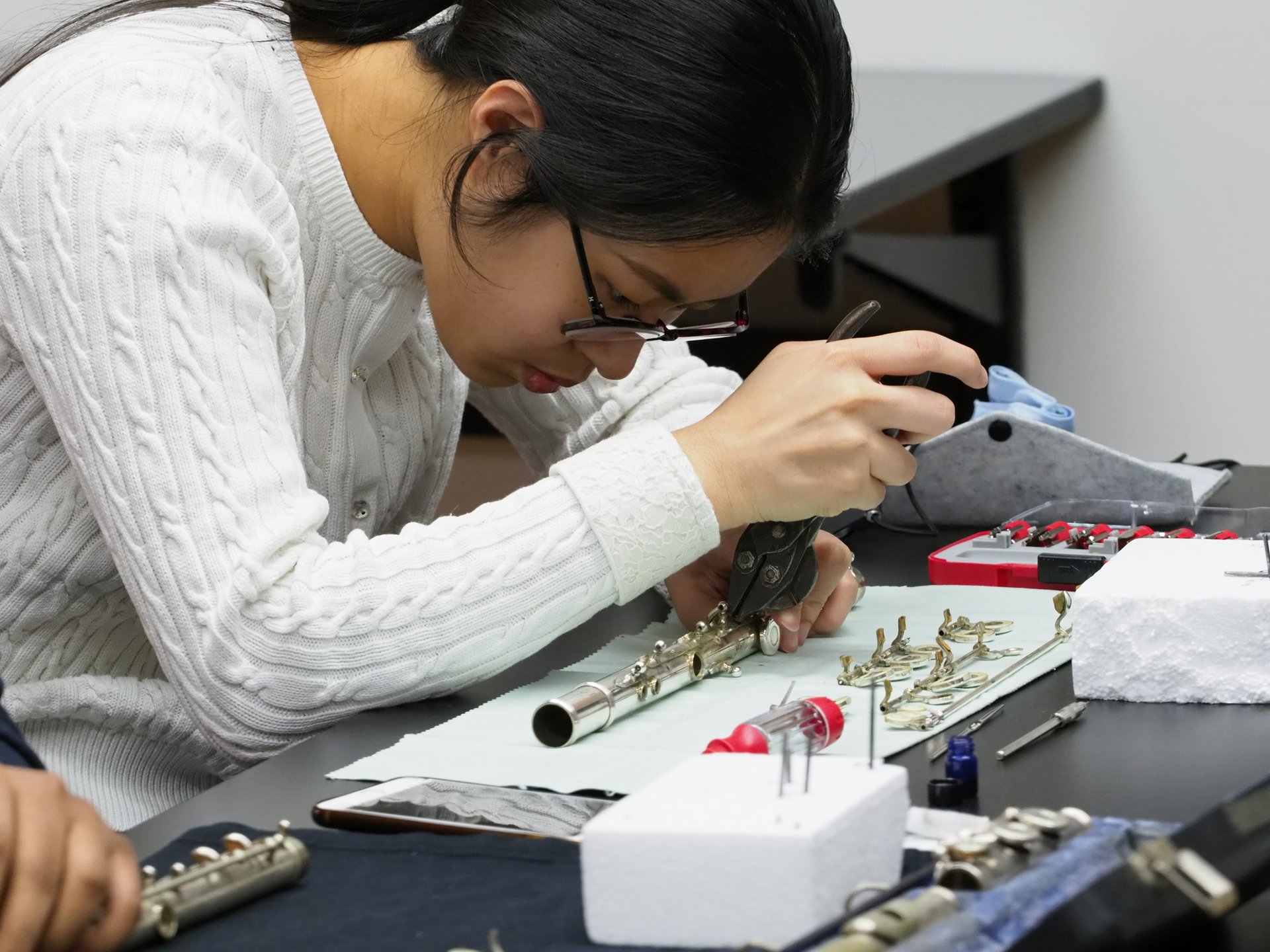 A student reconstructs a flute.