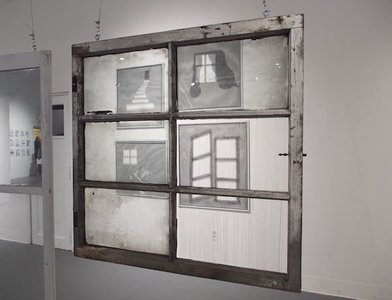 A four pained window hangs in a room