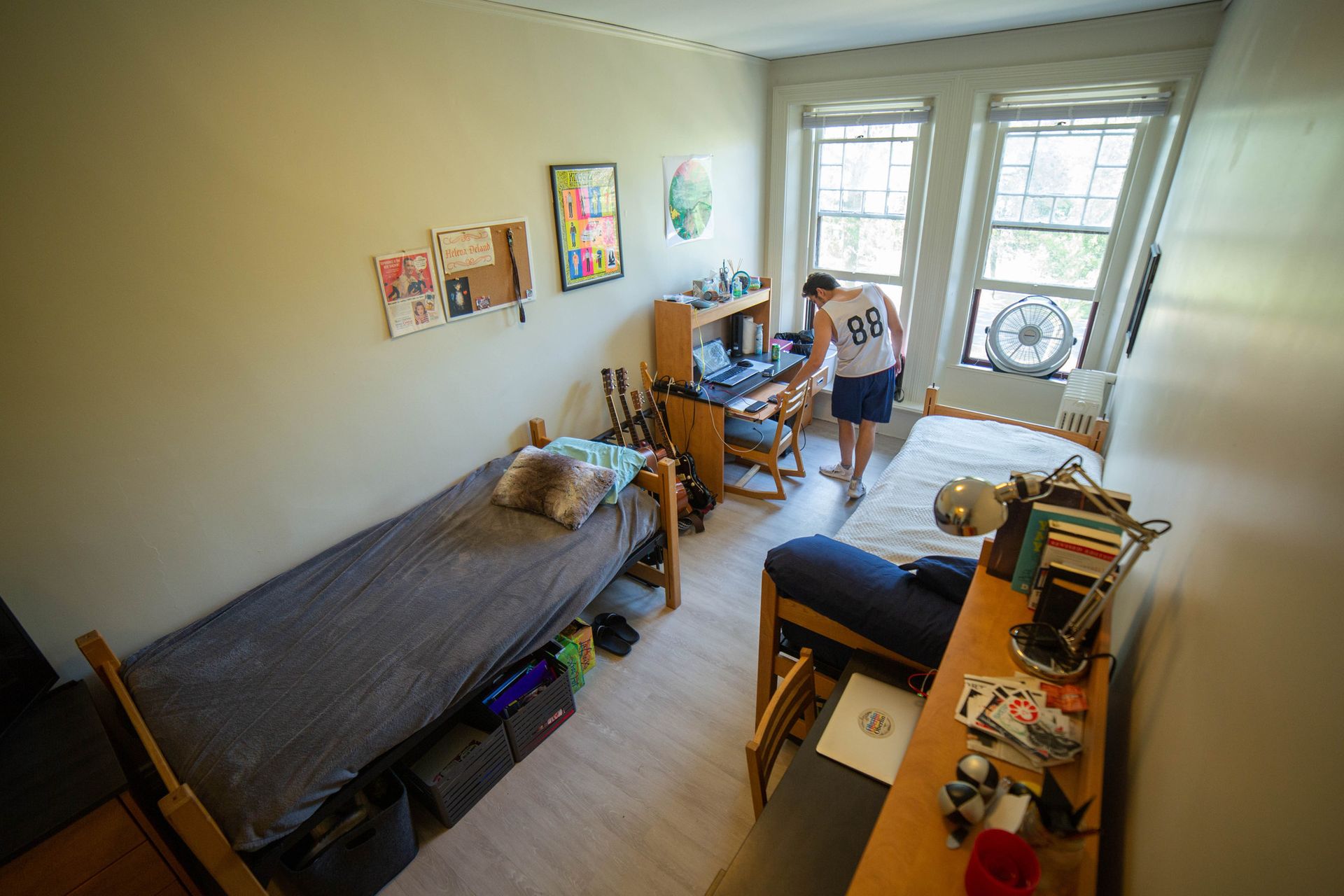 A picture of a long dorm room.