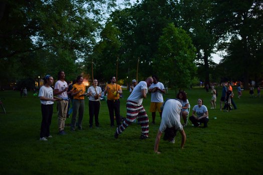 People gather around two people dancing.