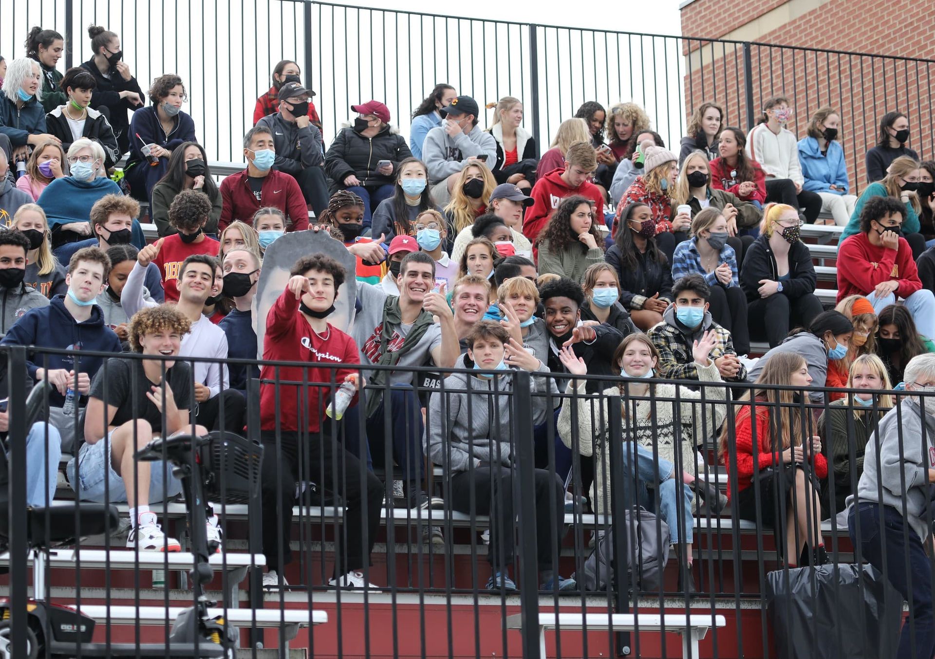 People cheer at a football game.