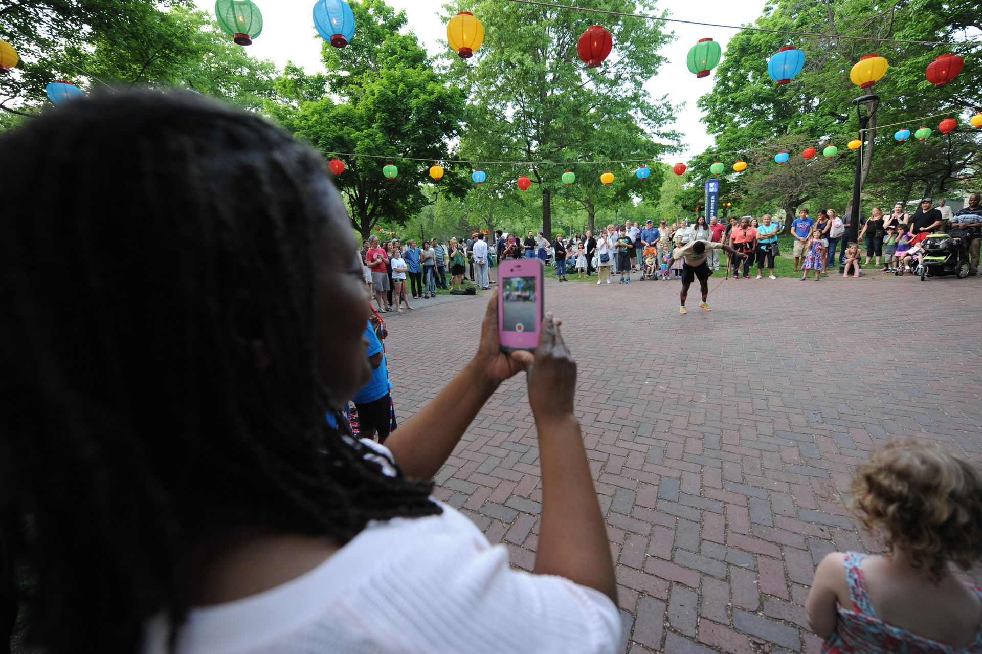 A person takes pictures of a person jumping rope.
