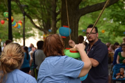A woman lights a candle in a lantern
