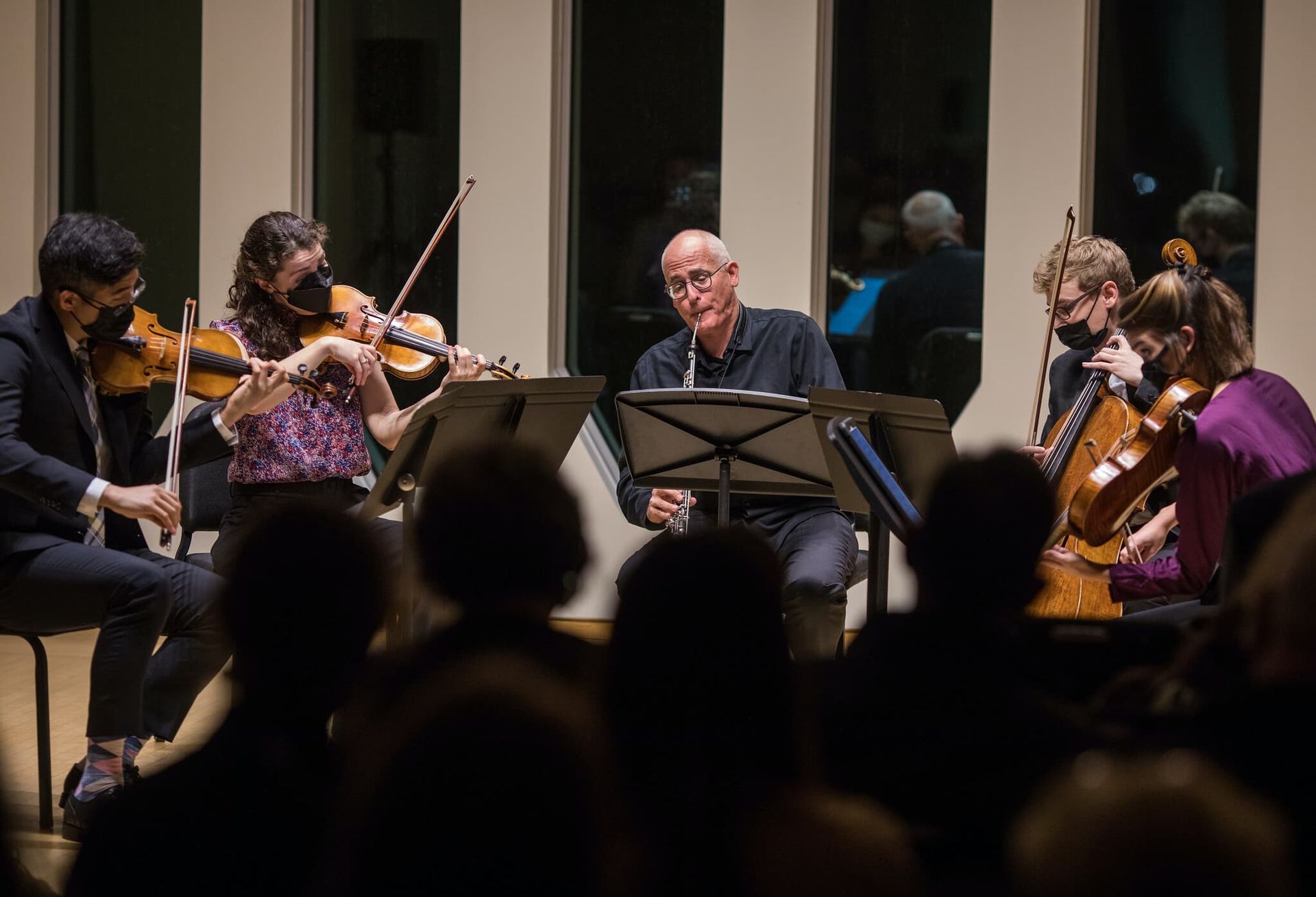 Five people give a musical performance.