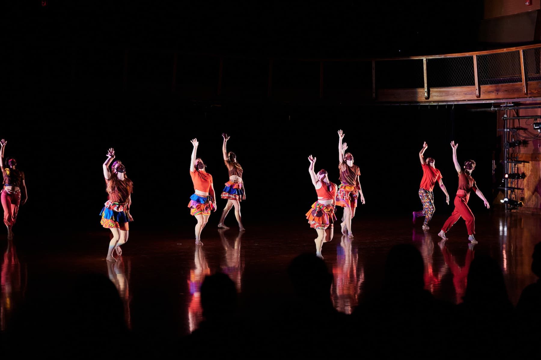 A group of dance students point their toes during a performance.