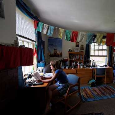 Prayer clothes hang from one end of a room to the other.