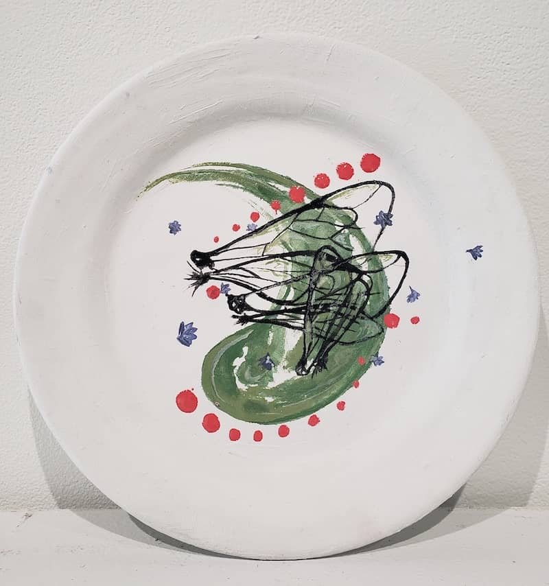 A ceramic plate with dots and teardrop in the center