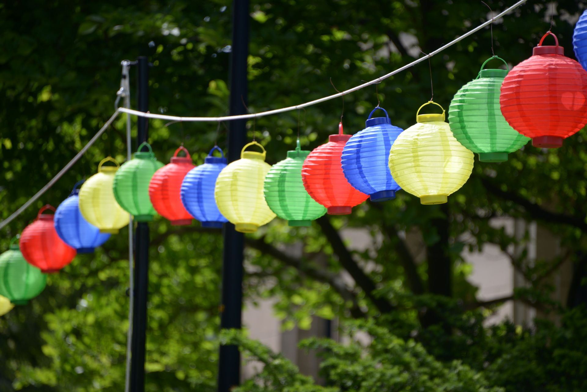 A long rope is filled with hanging lanterns.
