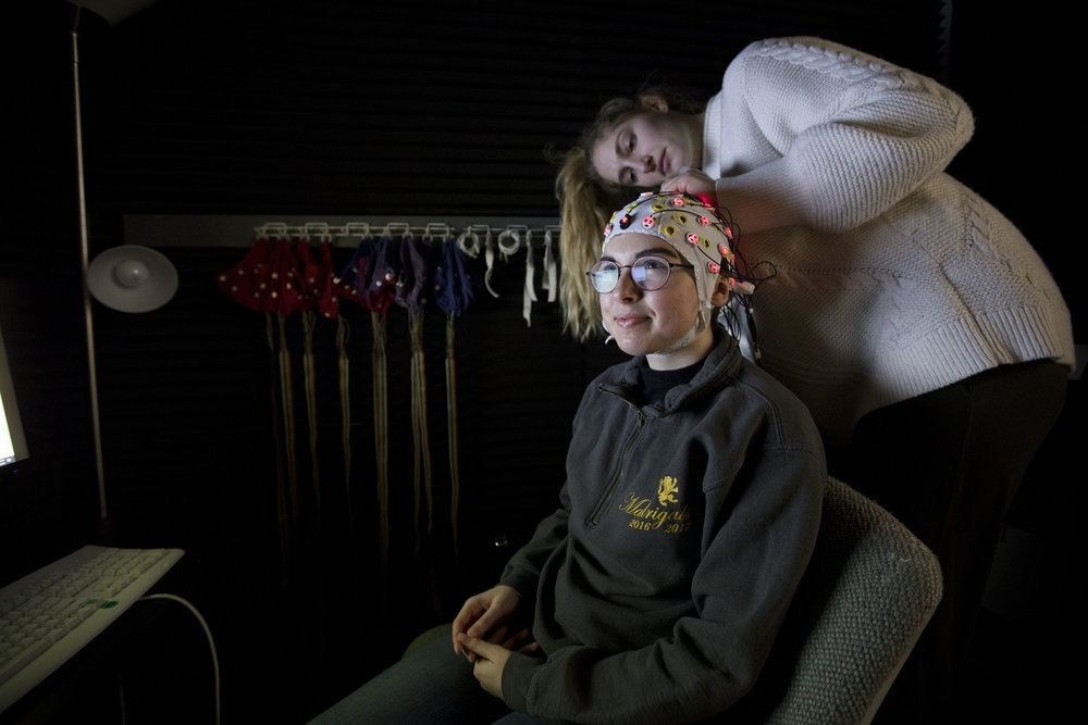 Corinne Marble '21 (seated) and Margaret Sammon '20 conduct face perception research in the psychology department's Electroencephalogram (EEG) lab.