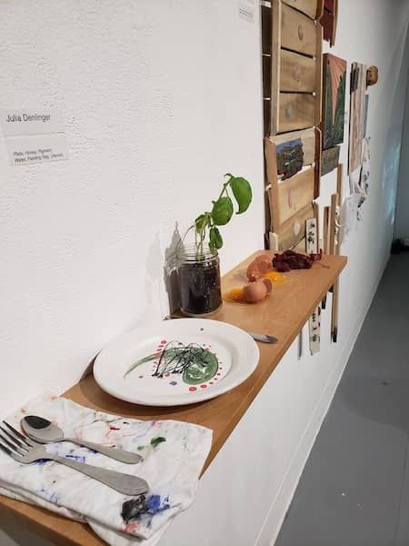 A long table mounted to the wall is set for dinner
