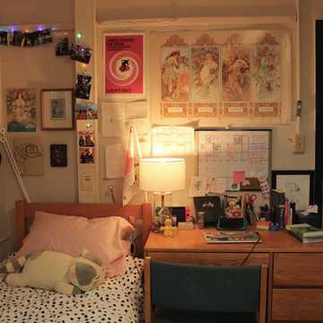 A mix of cultural prints, photos, lights, and tapestry.