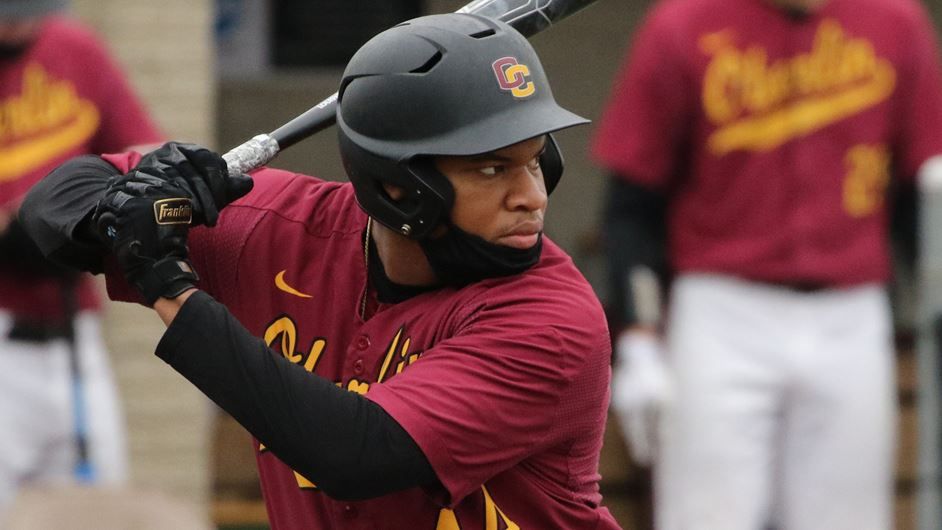 A student swings a baseball bat.