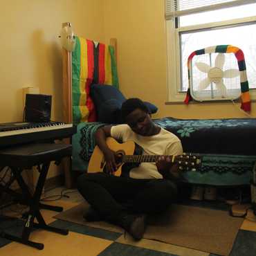 A flag drapes the headboard of a bed.