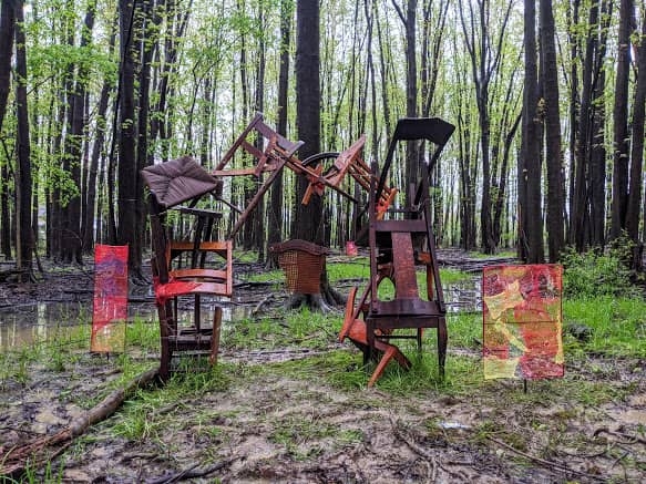 Chairs stacked on top of each other in a field