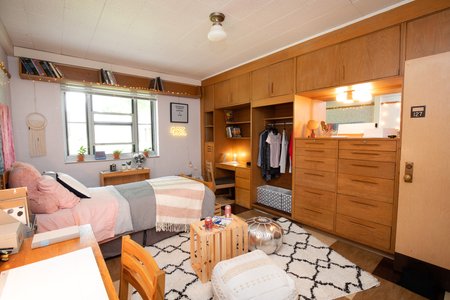 A small table lamp sits on a wooden desk.