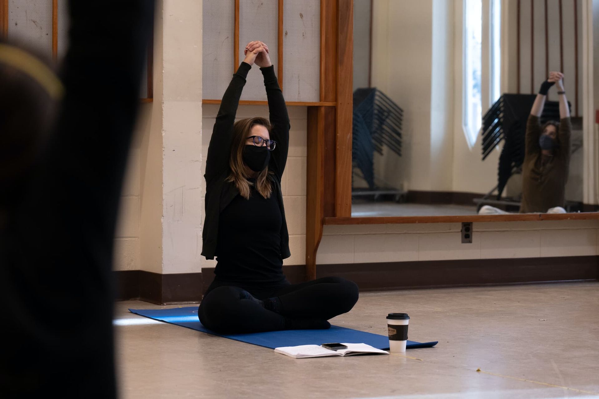 A woman stretches during a yoga class.