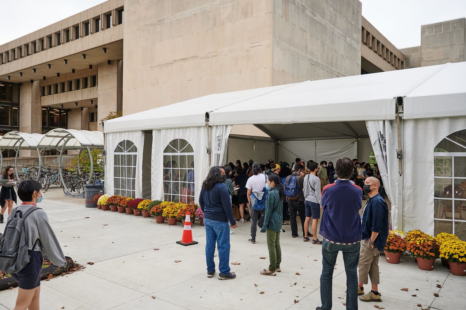 People file inside a tent