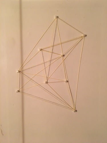 Strings and tacks make triangle shapes. 