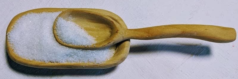 Wooden spoon and small wooden dish holding salt
