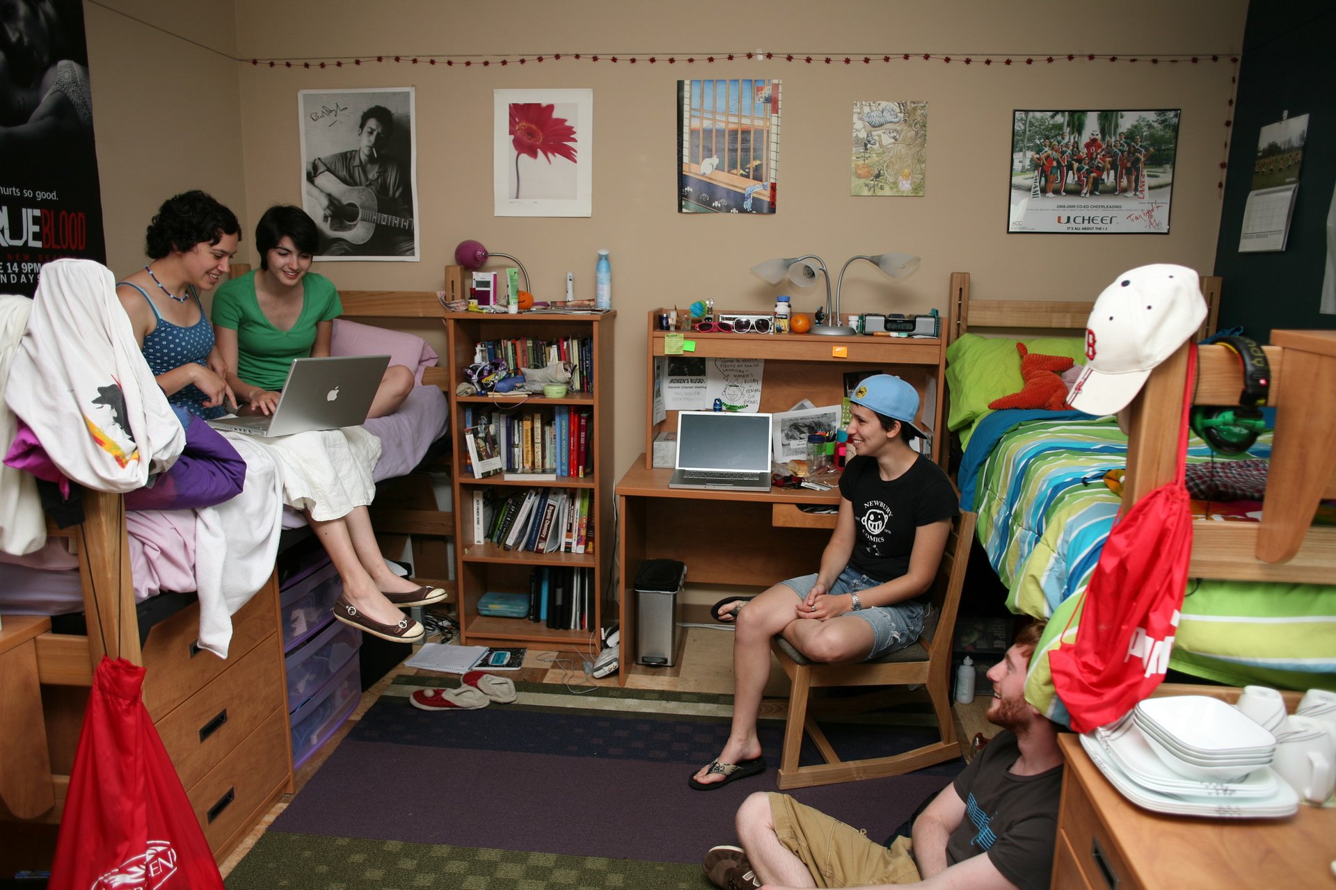 Pictures line the back wall of a room with a string of lights above.