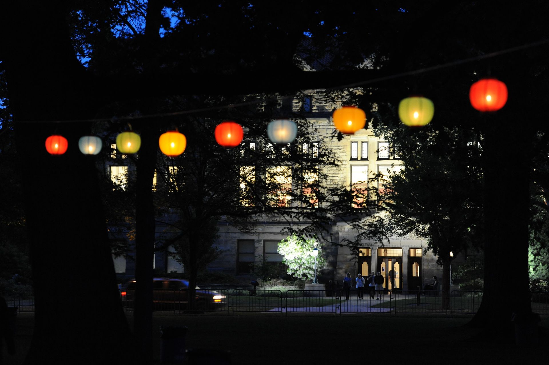 A building in the foreground of hanging lanterns 