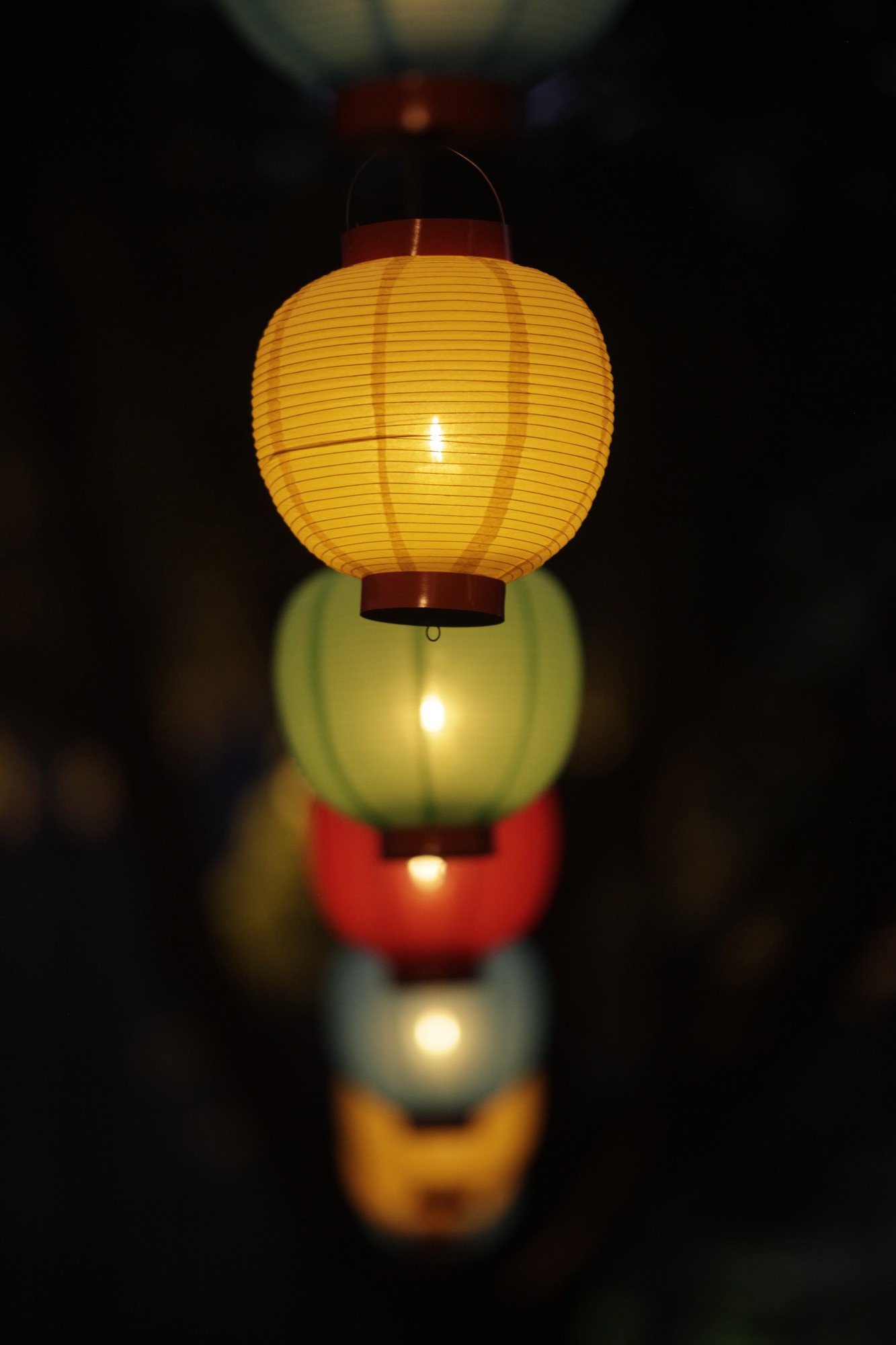 A row of lanterns in the dark