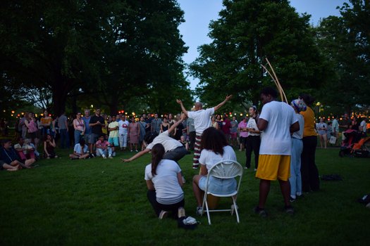 People gather around two people dancing.