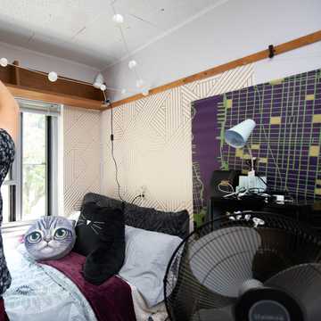 A student hangs a string of white balls from the walls in his room.
