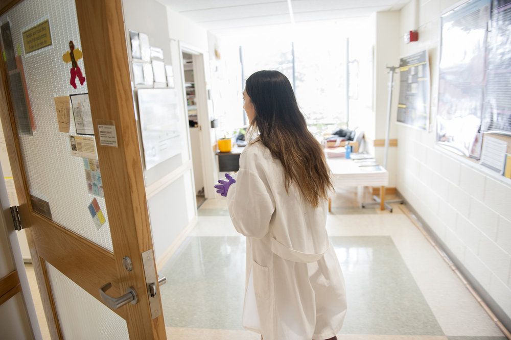 Student wearing lab coat.