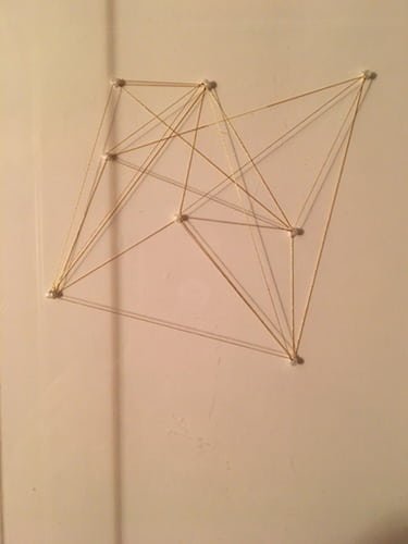 Strings and tacks make triangle shapes. 