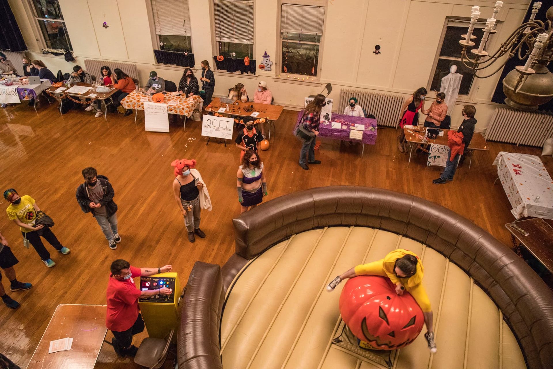 A line of students wait to ride a bucking pumpkin.