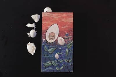 Egg shaped flowers, one with a face, in a filed.