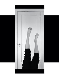 A picture of a person's legs against a white door.